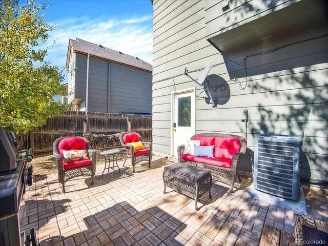 a view of a patio with table and chairs and potted plants