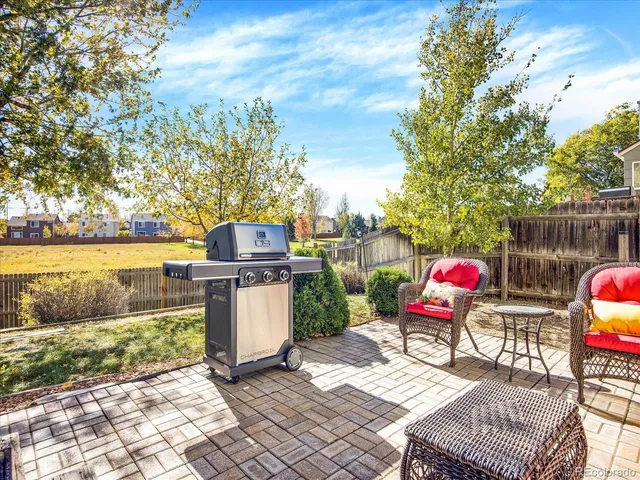 a backyard of a house with table and chairs