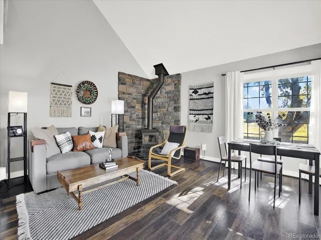 a living room with furniture wooden floor and wall painting
