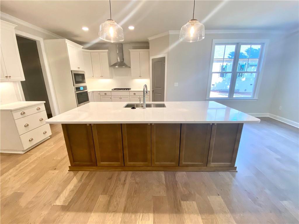3822 Poplar Tent Road Concord, NC 28027 - Photo 3 of 13 a view of a kitchen with cabinets and wooden floor