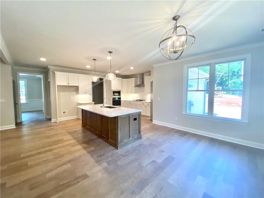 3822 Poplar Tent Road Concord, NC 28027 - Photo 4 of 13 a large white kitchen with a large window cabinets and stainless steel appliances