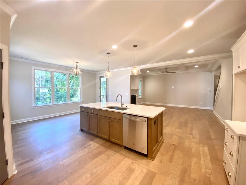 3822 Poplar Tent Road Concord, NC 28027 - Photo 6 of 13 a large white kitchen with a large window a sink and stainless steel appliances