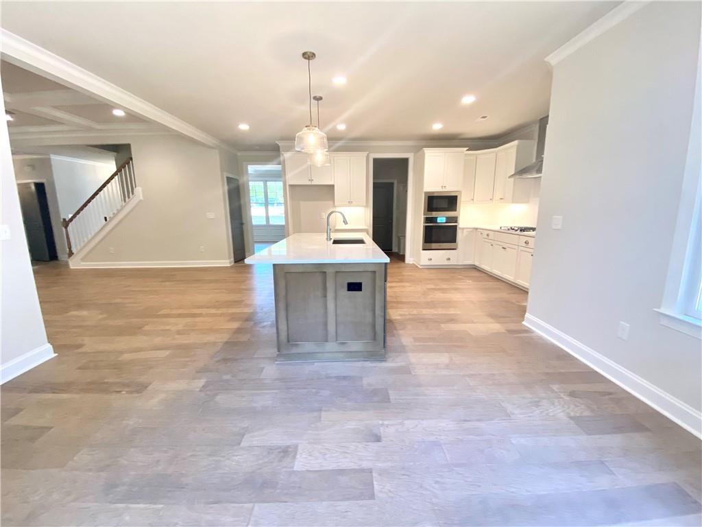 3822 Poplar Tent Road Concord, NC 28027 - Photo 7 of 13 a view of kitchen with kitchen island a sink appliances and a counter top space
