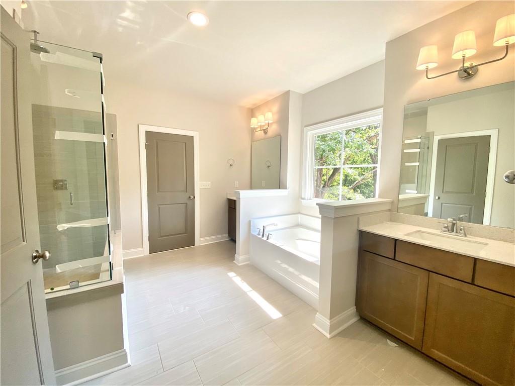 3822 Poplar Tent Road Concord, NC 28027 - Photo 9 of 13 a bathroom with a double vanity sink toilet and shower