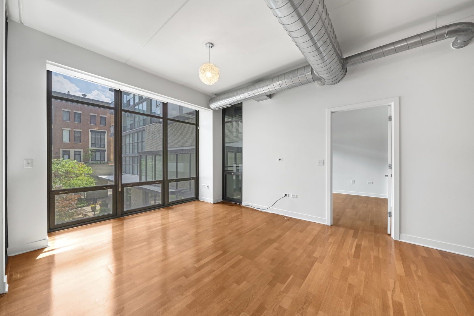 660 West Wayman Street, Unit 201B Chicago, IL 60661 - Photo 11 of 34 a view of an empty room with glass door