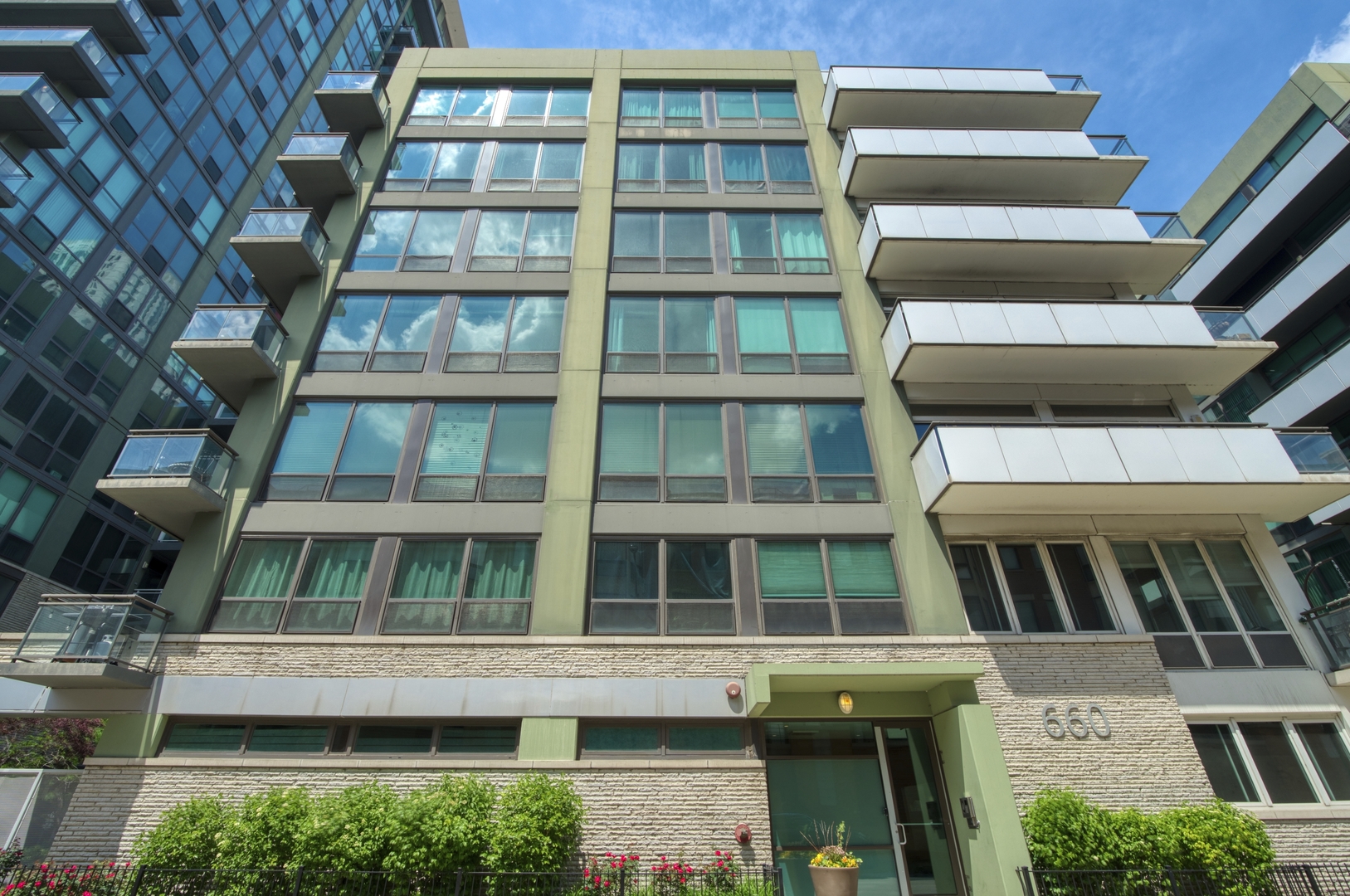 660 West Wayman Street, Unit 201B Chicago, IL 60661 - Photo 2 of 34 a tall building with large windows