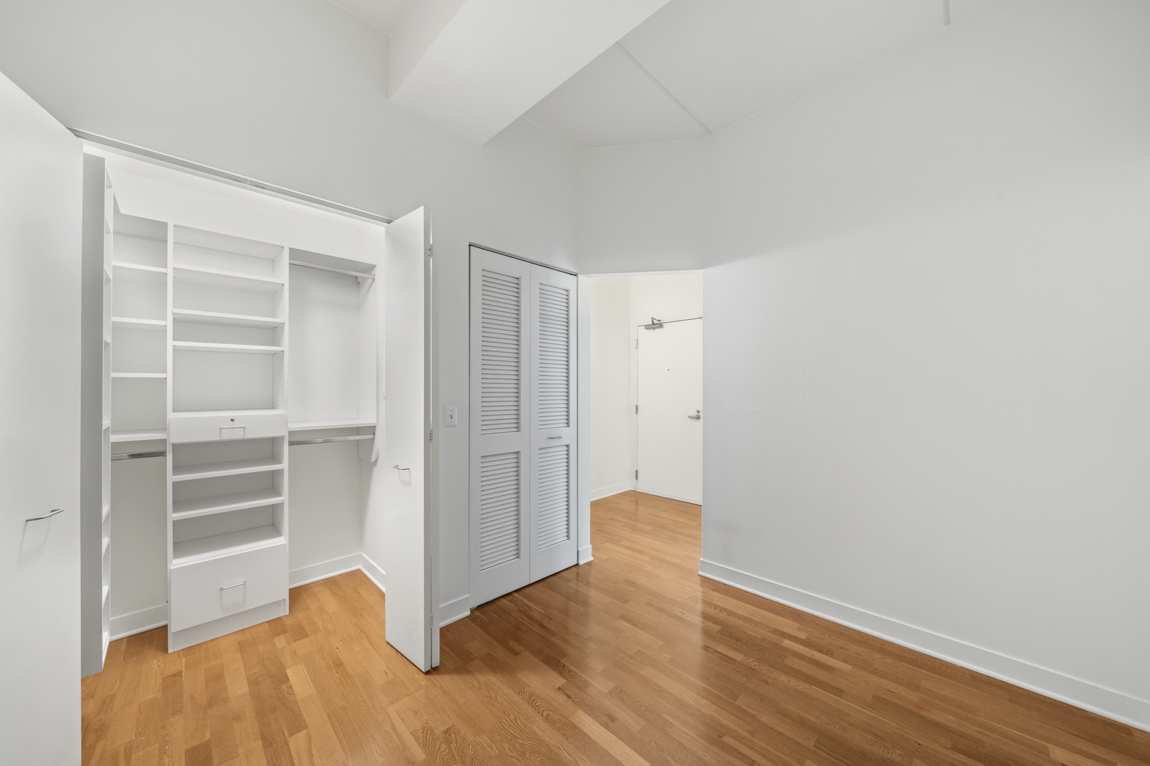 660 West Wayman Street, Unit 201B Chicago, IL 60661 - Photo 22 of 34 a view of an empty room with wooden floor and a window