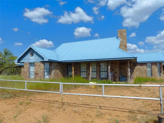 a view of a house with a backyard and porch