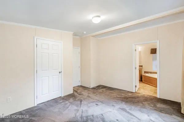 an empty room with closet and wooden floor