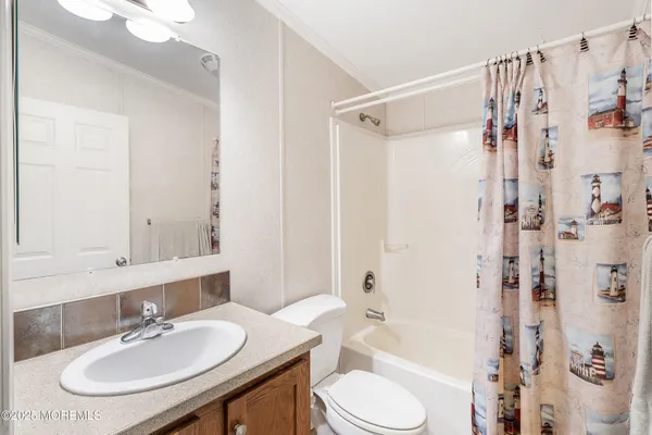 a bathroom with a sink toilet tub and shower