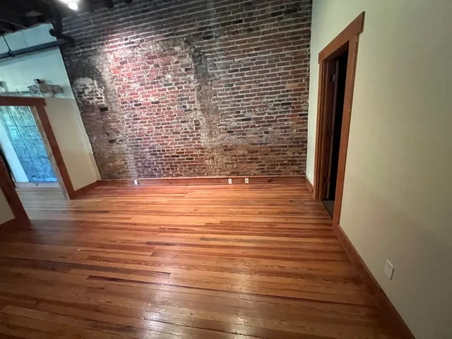 a view of hallway with wooden floor