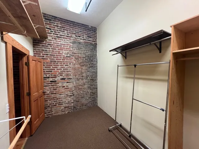a view of a refrigerator in kitchen and wooden floor
