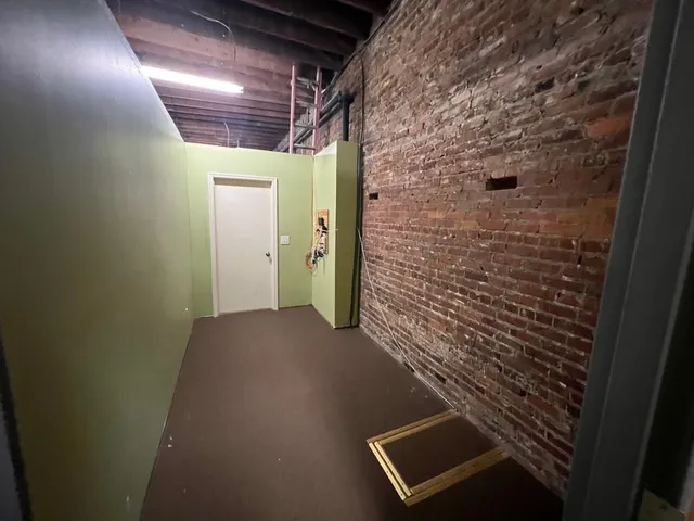 a view of a refrigerator in kitchen and wooden floor