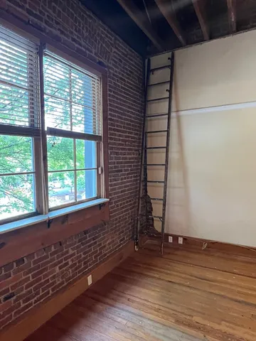 a view of a glass door with a tree from a window
