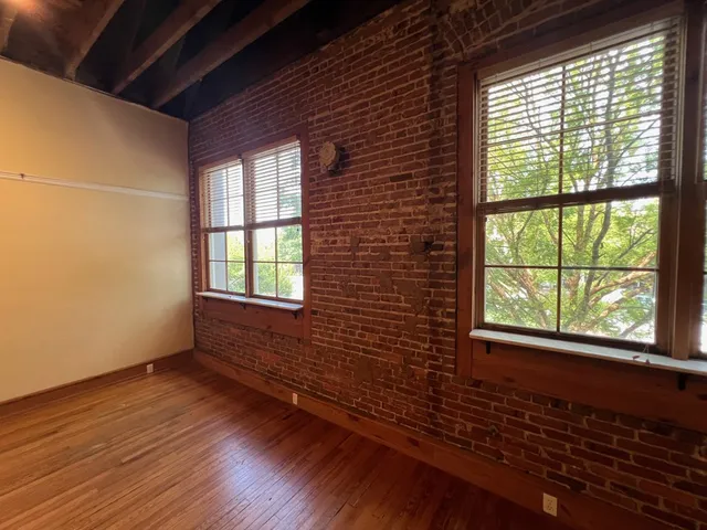a kitchen with stainless steel appliances granite countertop a sink a table and chairs