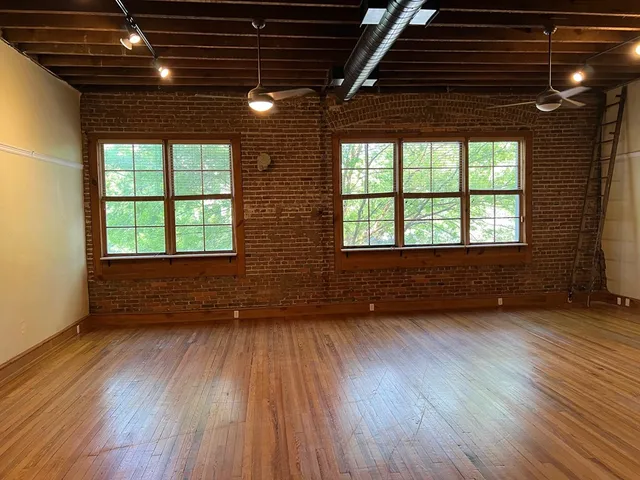 a view of room with wooden floor