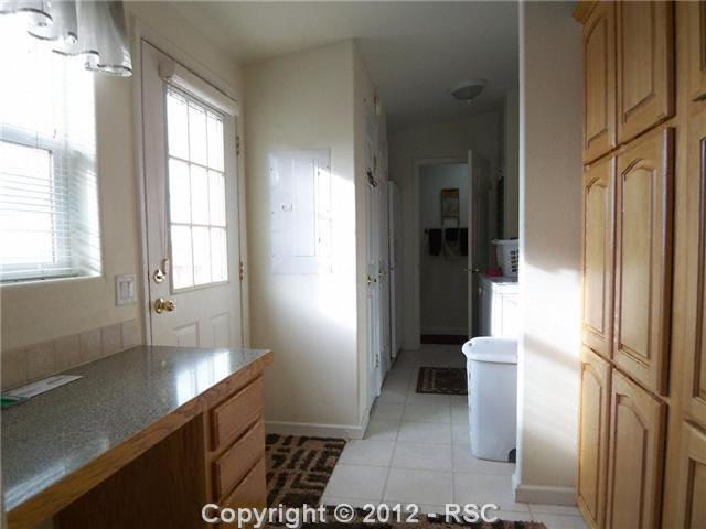 10770 Guthrie Road Calhan, CO 80808 - Photo 14 of 25 Mud rm w/pantry, desk area & door to deck