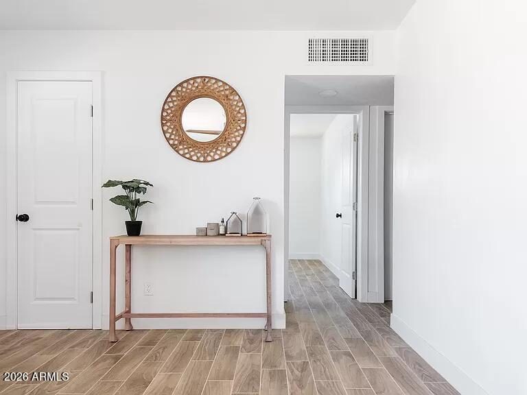 2915 West Griswold Road Phoenix, AZ 85051 - Photo 5 of 17 a view of a hallway with wooden floor