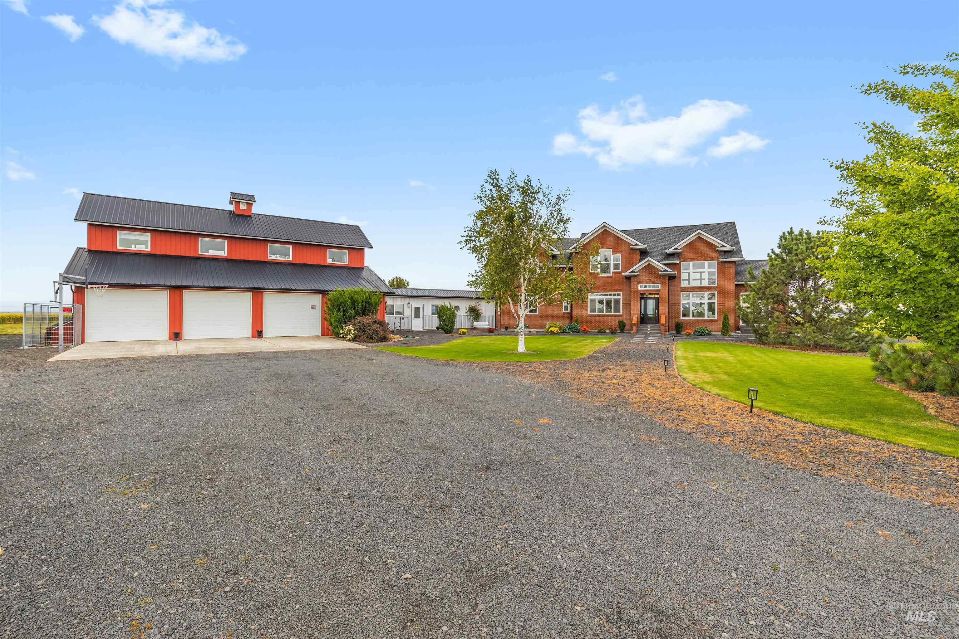 1513 Uniontown Road Genesee, ID 83832 - Photo 28 of 50 Expansive estate featuring a main residence, a detached garage, and an additional red outbuilding