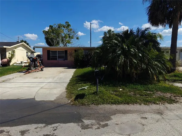 a view of a house with a yard and tree s