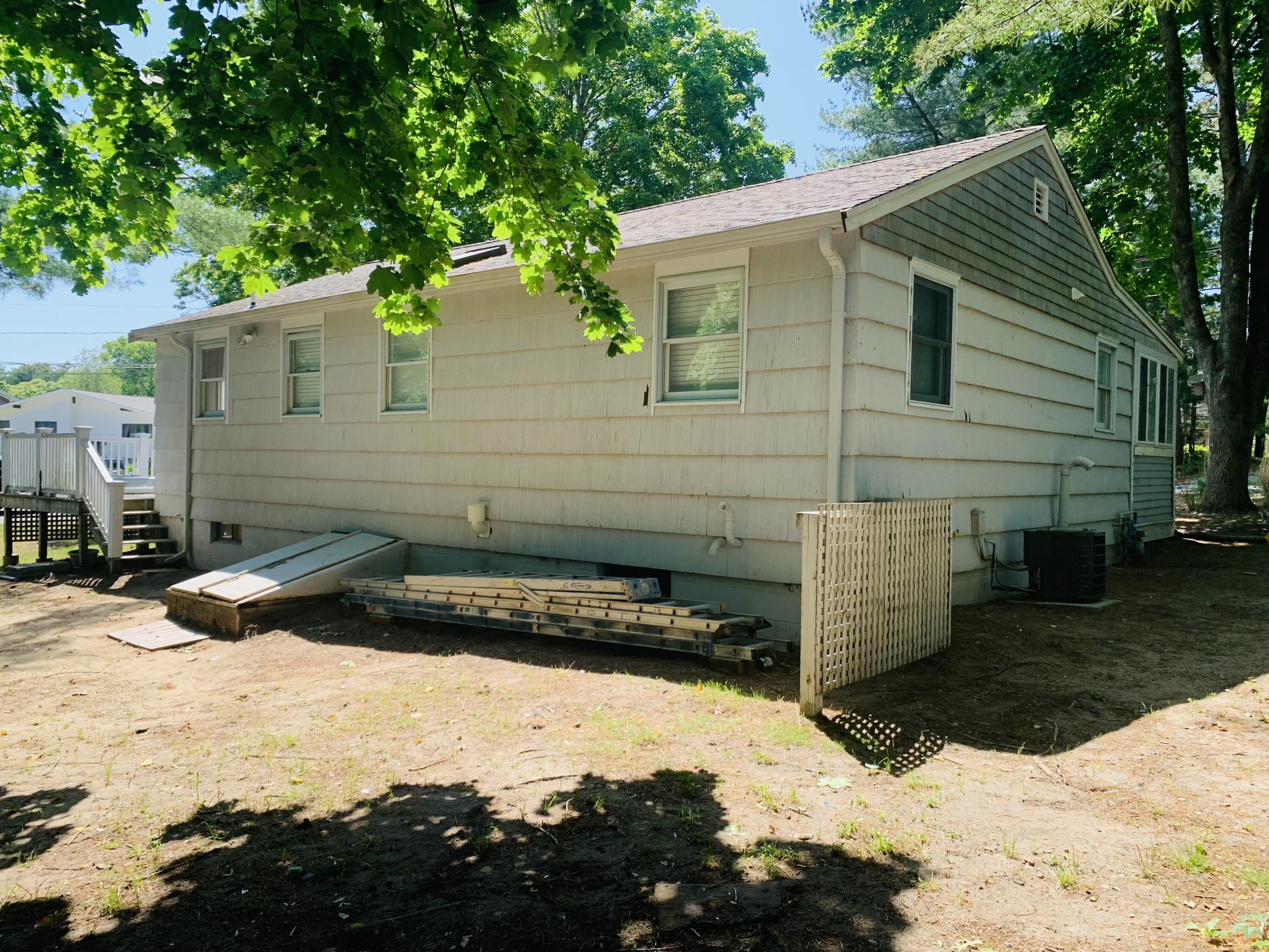 58 Buccaneer Way Mashpee, MA 02649 - Photo 3 of 8 a front view of a house with a yard