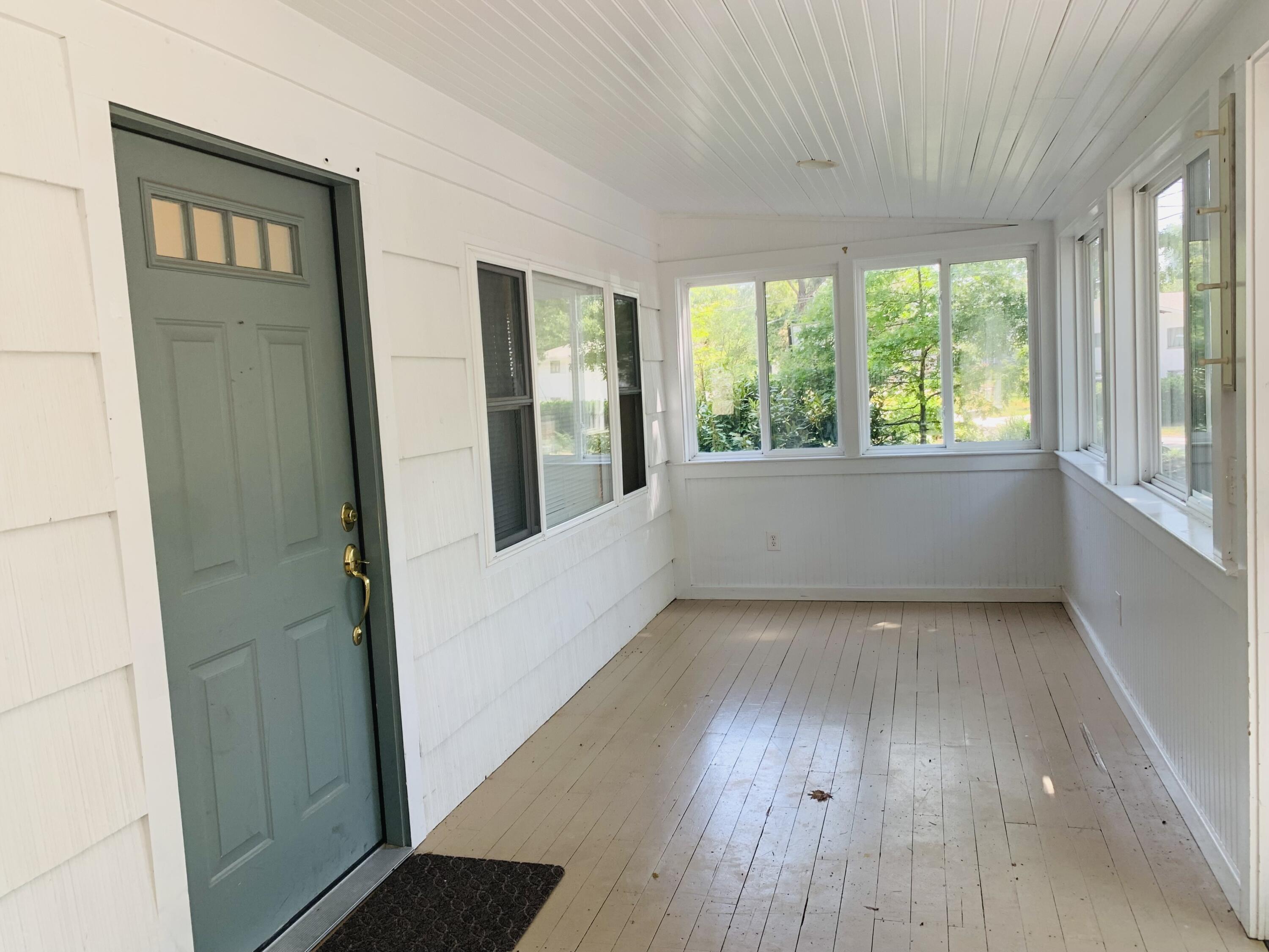 58 Buccaneer Way Mashpee, MA 02649 - Photo 4 of 8 an empty room with wooden floor and windows