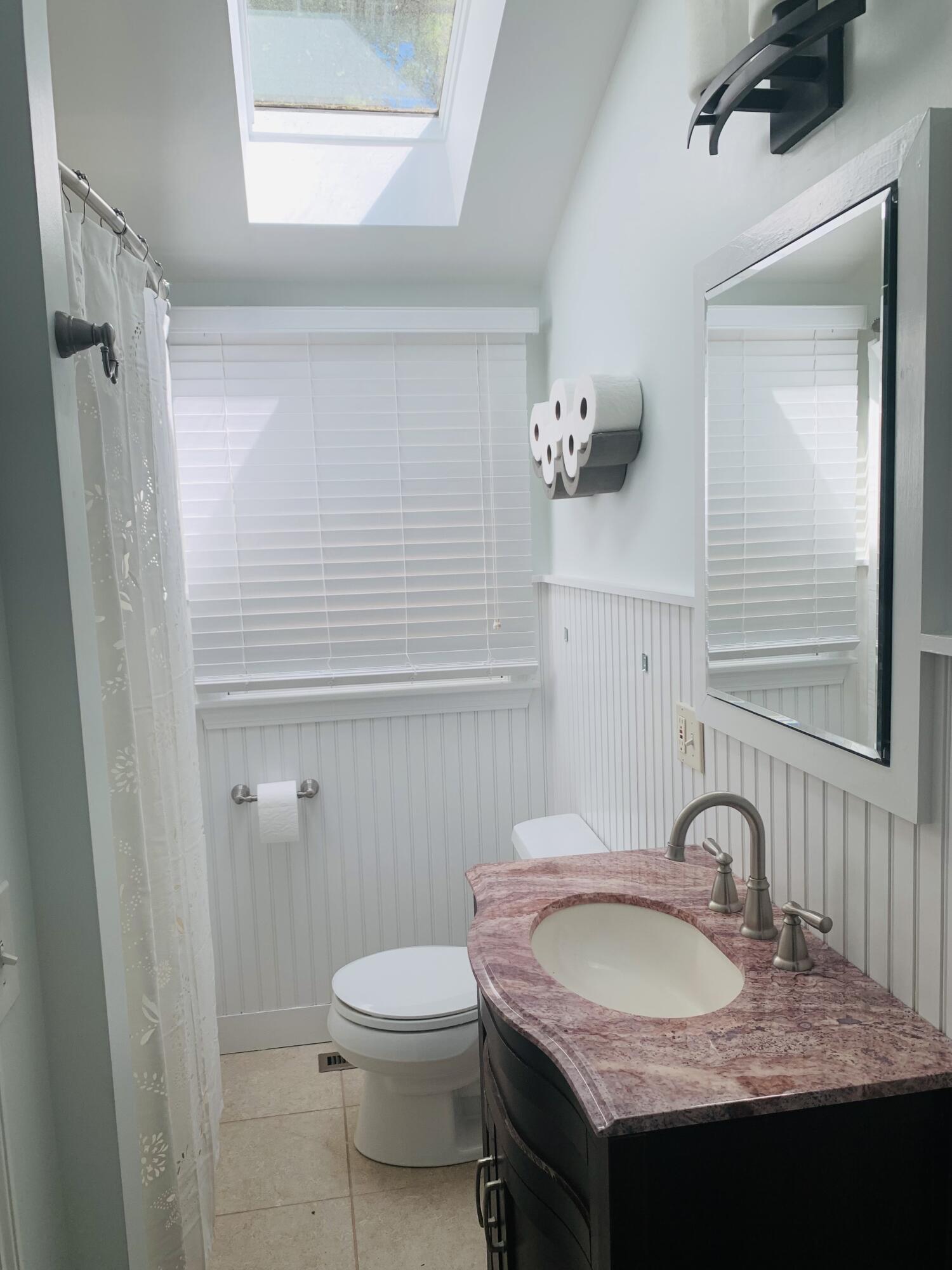 58 Buccaneer Way Mashpee, MA 02649 - Photo 6 of 8 a bathroom with a granite countertop sink a toilet and a mirror