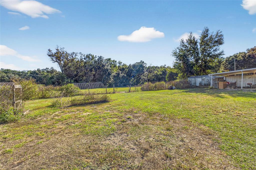 38710 Townsend Road Dade City, FL 33525 - Photo 14 of 17 a view of a swimming pool with an outdoor space and seating area
