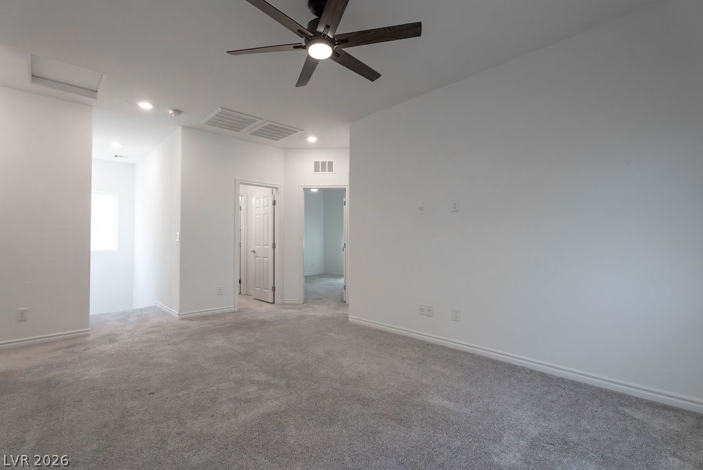 7126 Calvert Cliffs Street North Las Vegas, NV 89084 - Photo 18 of 44 A versatile bonus room awaits, offering ample space and overhead lighting for diverse activities.