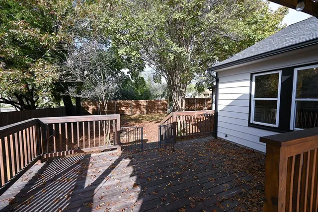 a view of a wooden chairs and bench on the deck