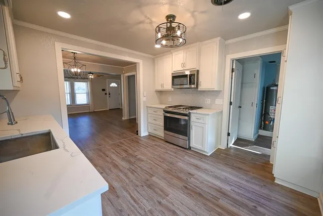 a kitchen with wooden floors and appliances