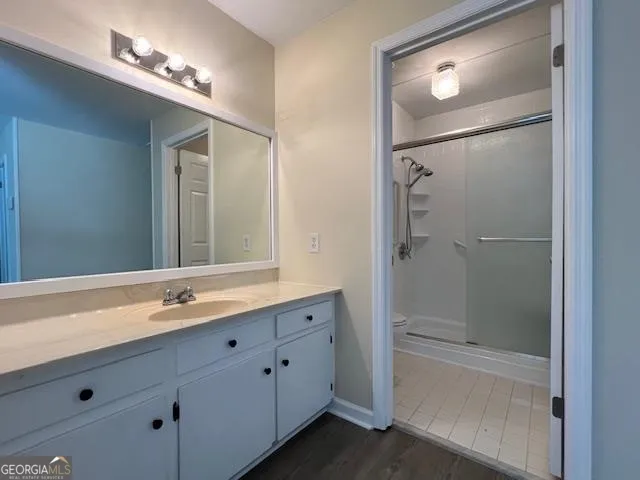 a bathroom with a double vanity sink and mirror with shower