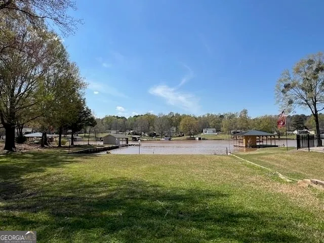 a view of a swimming pool with an outdoor seating and a yard