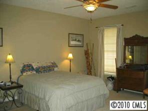 410 Bridle Path Farm Road Cleveland, NC 27013 - Photo 5 of 8 a bedroom with a bed and a chandelier