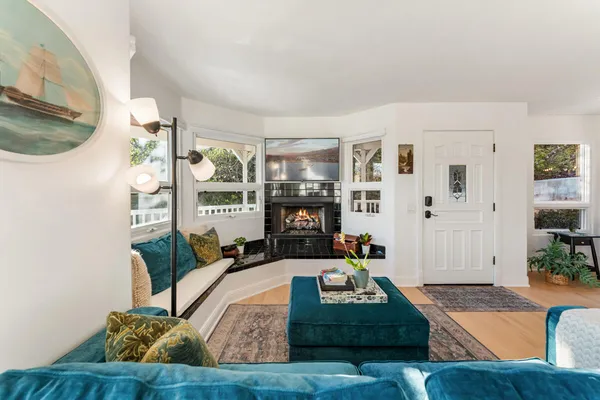 a living room with furniture and a fireplace