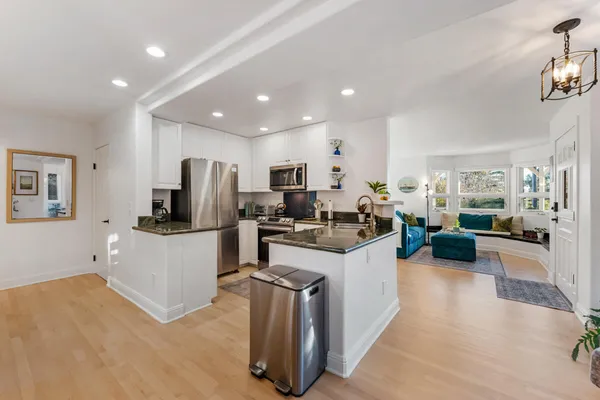 a kitchen with sink cabinets and living room