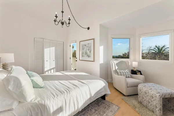 a bedroom with a bed couch and window