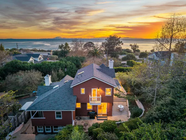 an aerial view of a house with a big yard