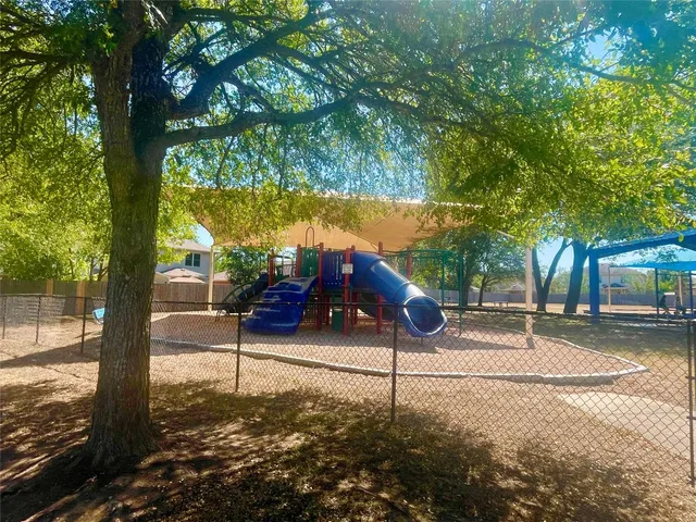 a view of a swimming pool and lounge chairs in patio