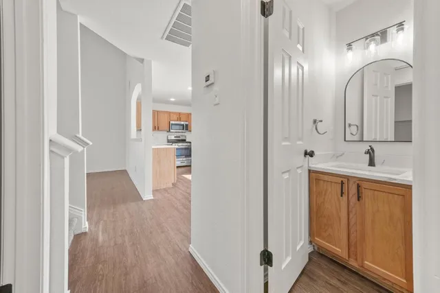 a kitchen with a table chairs stove and cabinets