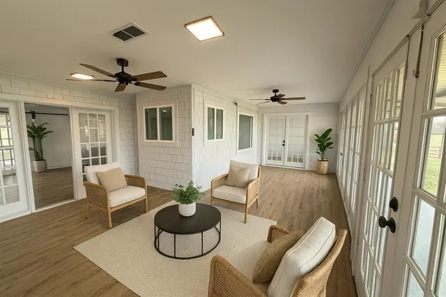 a living room with furniture and a large window