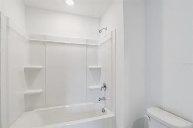 a bathroom with a bathtub and toilet