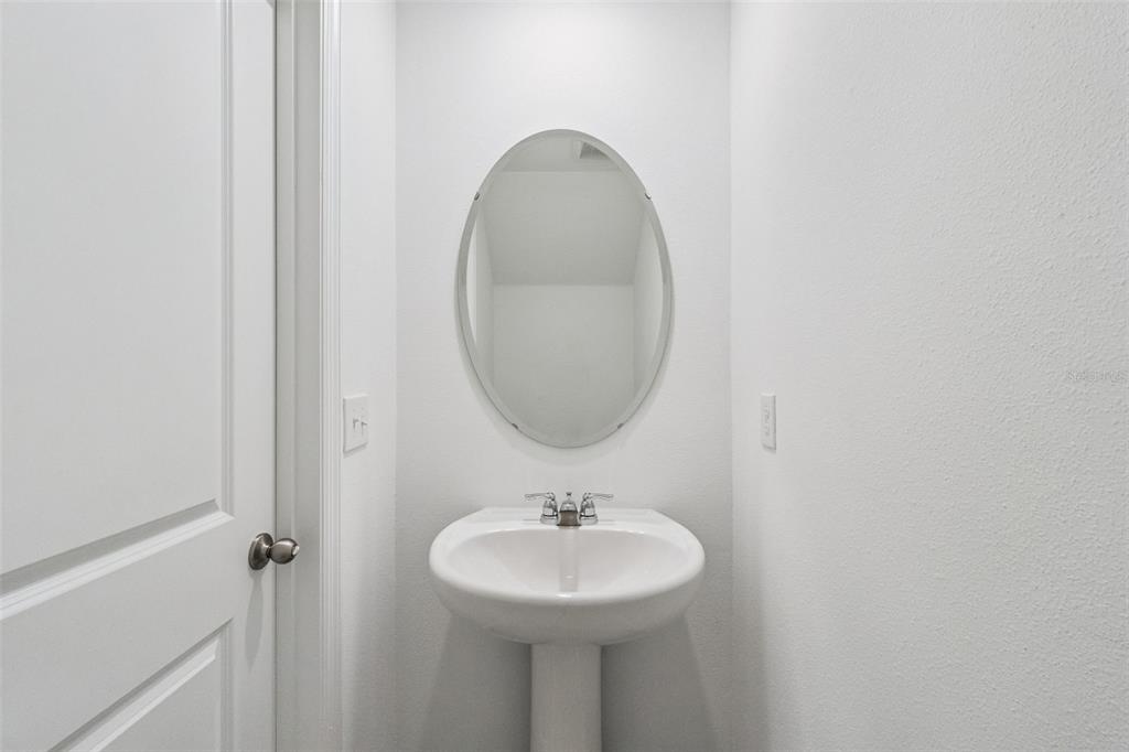 3613 Spire Drive Davenport, FL 33837 - Photo 14 of 20 a bathroom with a sink and a mirror