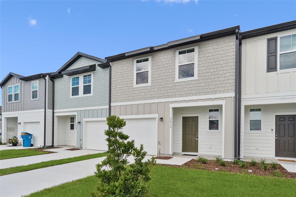 3613 Spire Drive Davenport, FL 33837 - Photo 18 of 20 a front view of a house with a yard and garage