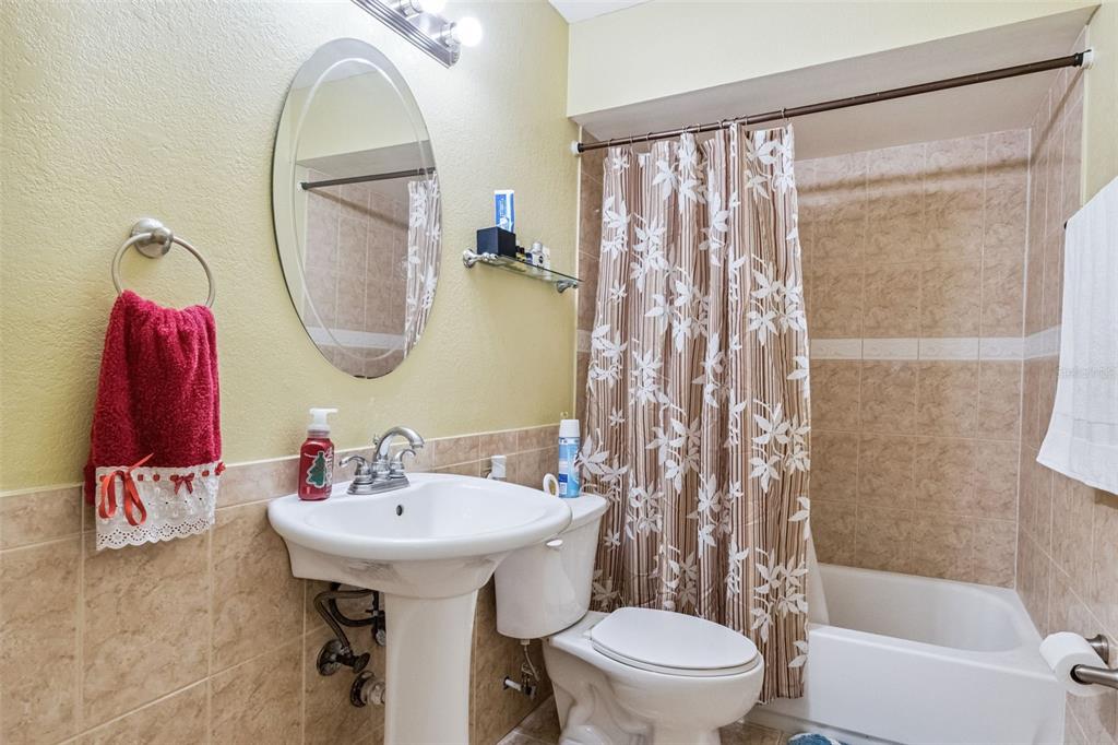 3613 Spire Drive Davenport, FL 33837 - Photo 8 of 20 a bathroom with a sink toilet and a mirror