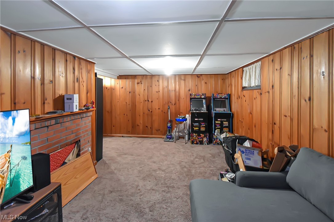 1068 Rushleigh Road Cleveland Heights, OH 44121 - Photo 18 of 22 Carpeted living room featuring wood walls