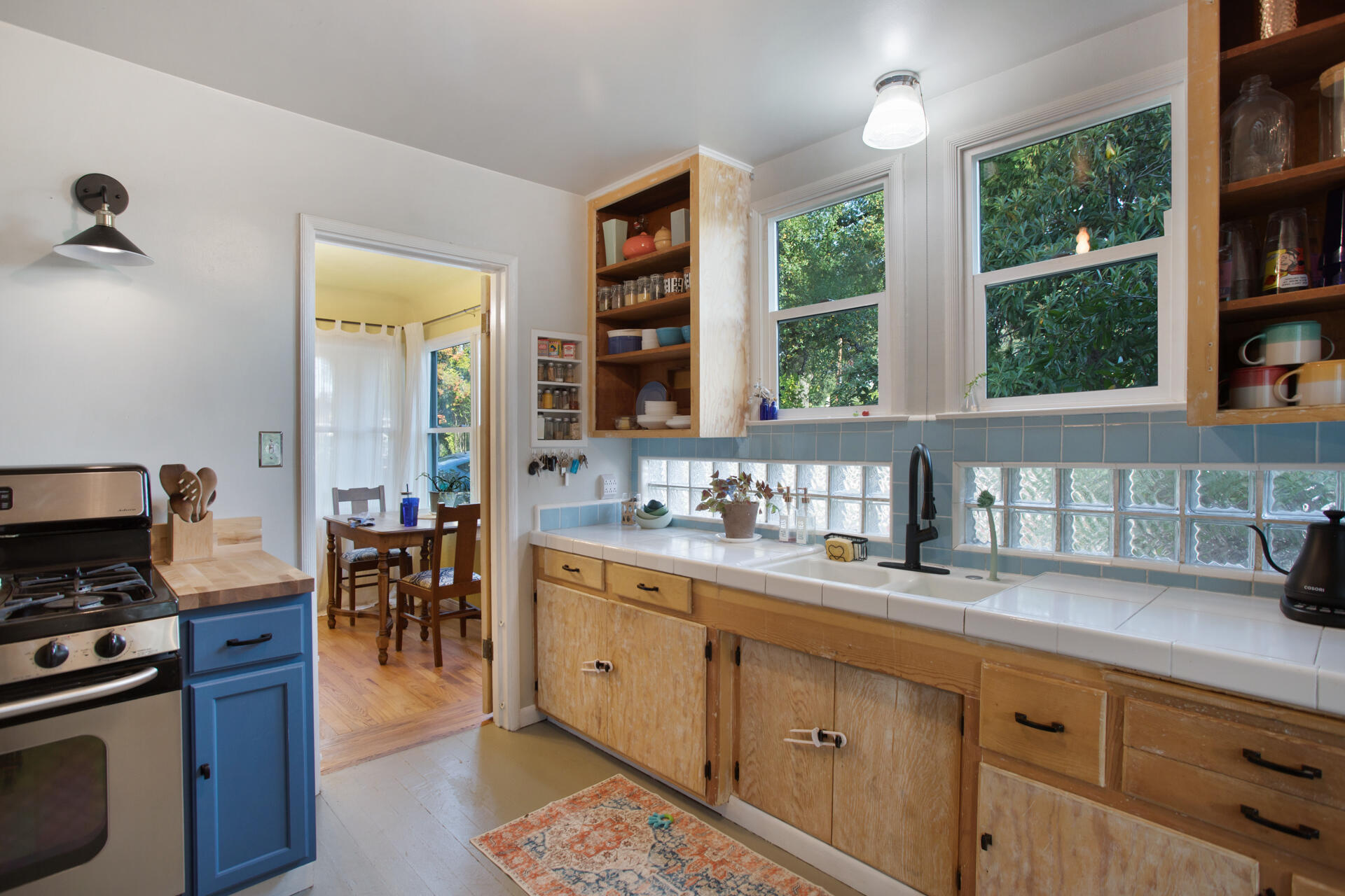 784 Lakeview Drive Redding, CA 96001 - Photo 4 of 14 a kitchen with granite countertop a stove a sink and a wooden cabinets