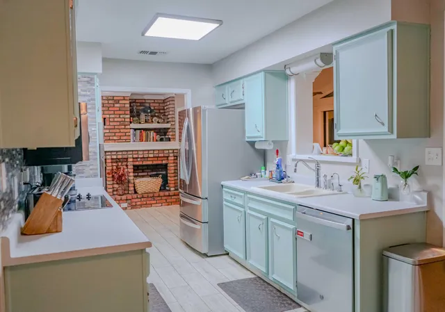 a room with a sink and a washer dryer
