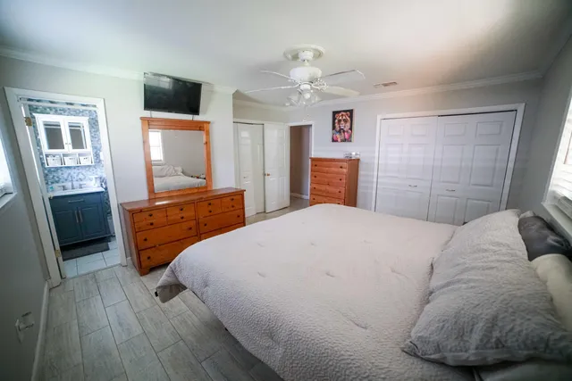 a bedroom with a bed and a television