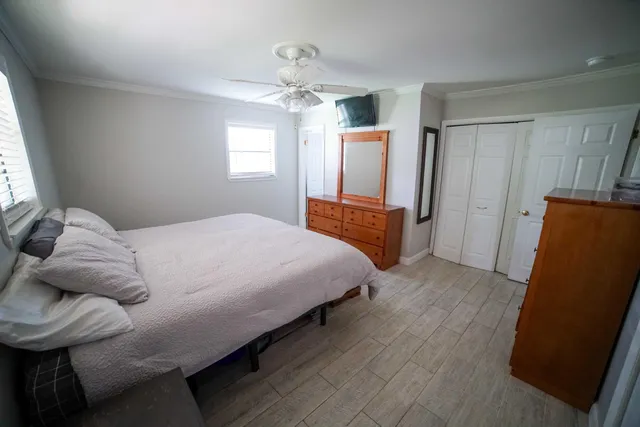 a bedroom with a bed and window